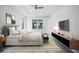 Main bedroom with a king-size bed, TV, and stylish decor at 45 Bunker Ln, Rotonda West, FL 33947