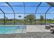 Inviting pool area with screened enclosure, offering scenic water views at 45 Bunker Ln, Rotonda West, FL 33947