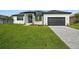 Modern home with a two-car garage and beautifully landscaped front yard at 45 Bunker Ln, Rotonda West, FL 33947