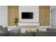 Living room with wood accent wall, built-in media console, and marble floors at 45 Bunker Ln, Rotonda West, FL 33947