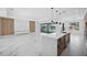 Open-concept kitchen with large island, marble flooring, and pool view at 45 Bunker Ln, Rotonda West, FL 33947