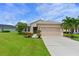Single-story home with landscaped yard and large green lawn at 12271 Lavender Loop, Bradenton, FL 34212