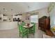 Charming dining area with green chairs and a view to the kitchen at 12271 Lavender Loop, Bradenton, FL 34212
