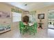 Bright dining area with green chairs and wood table, adjacent to kitchen at 12271 Lavender Loop, Bradenton, FL 34212
