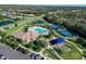 Aerial view showing community pool, tennis, pickleball courts, playground, and clubhouse at 12271 Lavender Loop, Bradenton, FL 34212