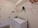 Laundry room with washer, dryer, and shelving at 12271 Lavender Loop, Bradenton, FL 34212