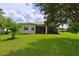 Home with covered patio, lush lawn, and mature trees at 12271 Lavender Loop, Bradenton, FL 34212