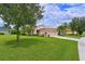 Single-story home with landscaped yard and large green lawn at 12271 Lavender Loop, Bradenton, FL 34212