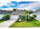 Single-story house with a two-car garage and a lush green lawn at 7448 Ridgelake Cir, Bradenton, FL 34203