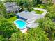Drone shot showcasing a single story home, pool, and surrounding tropical foliage at 1389 Harbor Dr, Sarasota, FL 34239