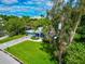 Single-story home with a paver driveway, lush green lawn, and a tranquil neighborhood setting at 1389 Harbor Dr, Sarasota, FL 34239