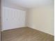Bedroom featuring wood-look floors and a closet with white louvered doors at 4973 Village Gardens Dr # 50, Sarasota, FL 34234