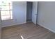 Bedroom with wood-look floors and a doorway to another room at 4973 Village Gardens Dr # 50, Sarasota, FL 34234