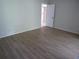 Bedroom with wood-look floors showcasing access to other rooms at 4973 Village Gardens Dr # 50, Sarasota, FL 34234