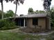Exterior view of the house with landscaping and a screened-in patio at 4973 Village Gardens Dr # 50, Sarasota, FL 34234