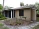 Home exterior view showing a screened in porch, a window and a tan exterior paint color at 4973 Village Gardens Dr # 50, Sarasota, FL 34234