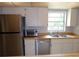 Bright kitchen features stainless steel appliances and light wood countertops at 4973 Village Gardens Dr # 50, Sarasota, FL 34234