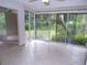 Sunroom with tiled flooring and sliding glass doors leading to backyard at 4973 Village Gardens Dr # 50, Sarasota, FL 34234