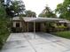 Tan house with carport and landscaped yard at 4973 Village Gardens Dr # 50, Sarasota, FL 34234