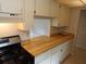 Efficient kitchen with wood countertops and stainless steel appliances at 4973 Village Gardens Dr # 50, Sarasota, FL 34234