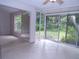 Sunroom with tiled flooring and sliding glass doors leading to backyard at 4973 Village Gardens Dr # 50, Sarasota, FL 34234