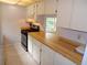 Efficient kitchen with wood countertops and stainless steel appliances at 4973 Village Gardens Dr # 50, Sarasota, FL 34234