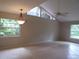 Bright dining room with tile floors, large windows, and a ceiling fan at 4973 Village Gardens Dr # 50, Sarasota, FL 34234