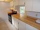Efficient kitchen with wood countertops and stainless steel appliances at 4973 Village Gardens Dr # 50, Sarasota, FL 34234