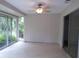 Sunroom with tiled flooring and sliding glass doors leading to backyard at 4973 Village Gardens Dr # 50, Sarasota, FL 34234