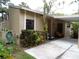 House exterior with carport, landscaping, and hose at 4973 Village Gardens Dr # 50, Sarasota, FL 34234