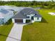 Modern home with dark brown garage door and paver driveway at 1094 Rotonda Cir, Rotonda West, FL 33947