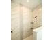 Walk-in shower with marble-look tile and built-in shelves at 1094 Rotonda Cir, Rotonda West, FL 33947