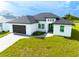 Modern home with dark brown garage door and paver driveway at 1094 Rotonda Cir, Rotonda West, FL 33947
