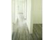 Bright hallway with wood-look flooring and access to bedrooms at 1094 Rotonda Cir, Rotonda West, FL 33947