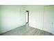 Spacious bedroom with wood-look floors and double doors at 1094 Rotonda Cir, Rotonda West, FL 33947