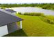 Backyard patio and lake view from modern home at 1094 Rotonda Cir, Rotonda West, FL 33947