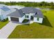 Modern home with dark brown garage door and paver driveway at 1094 Rotonda Cir, Rotonda West, FL 33947