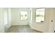 Bright dining area with large windows and wood-look floors at 1094 Rotonda Cir, Rotonda West, FL 33947