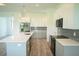 Modern kitchen with island, gray cabinets and white countertops at 1094 Rotonda Cir, Rotonda West, FL 33947
