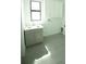 Laundry room with gray cabinets and tile floor at 1094 Rotonda Cir, Rotonda West, FL 33947