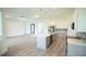 Open concept kitchen with island, stainless steel appliances, and gray cabinets at 1094 Rotonda Cir, Rotonda West, FL 33947
