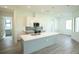 Modern kitchen with island, gray cabinets and white countertops at 1094 Rotonda Cir, Rotonda West, FL 33947