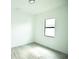 Simple bedroom with wood-look floors and window at 1094 Rotonda Cir, Rotonda West, FL 33947