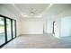 Spacious bedroom with gray flooring and sliding glass doors at 1094 Rotonda Cir, Rotonda West, FL 33947