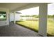 Covered patio overlooks a serene backyard with water view at 1094 Rotonda Cir, Rotonda West, FL 33947