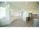 Open floor plan showcasing kitchen island and living room with wood-look floors at 1094 Rotonda Cir, Rotonda West, FL 33947