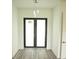 Bright entryway with double doors and wood-look floors at 1094 Rotonda Cir, Rotonda West, FL 33947