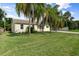 Charming single-story home with lush lawn and palm trees at 521 Live Oak St, Venice, FL 34285