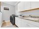 Laundry room with white cabinets and granite countertop at 4507 Terrazza Ct, Bradenton, FL 34211