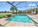 Relaxing screened-in pool with fountains and lounge chairs at 4507 Terrazza Ct, Bradenton, FL 34211